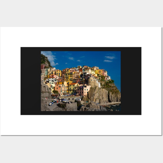 View on the cliff town of Manarola, one of the colorful Cinque Terre on the Italian west coast Wall Art by Dolfilms